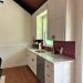 Single-walled kitchen inside the 'Modern Schoolhouse' project in Texas by DreamMaker.